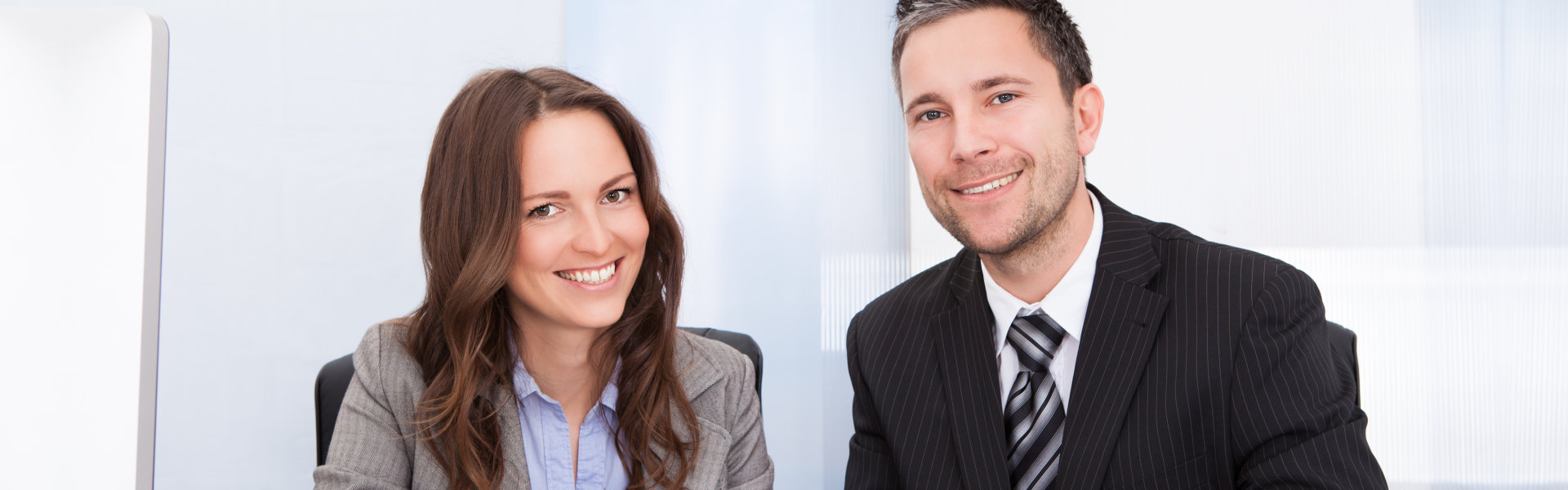 business man and woman smiling