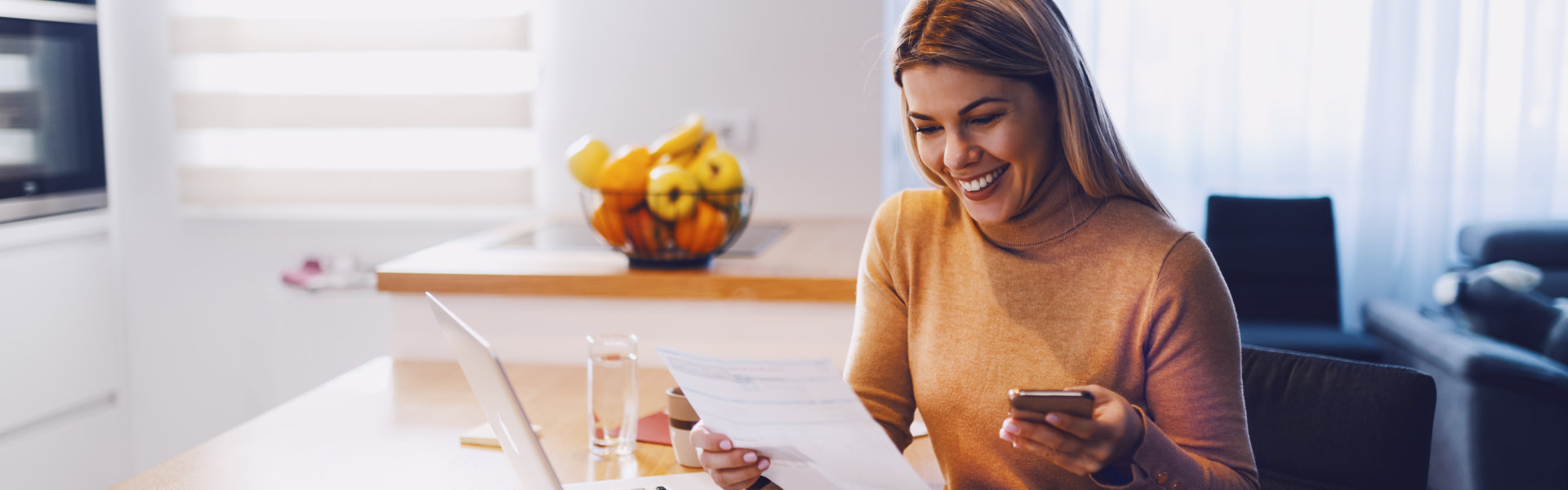 woman holding a document and her phone