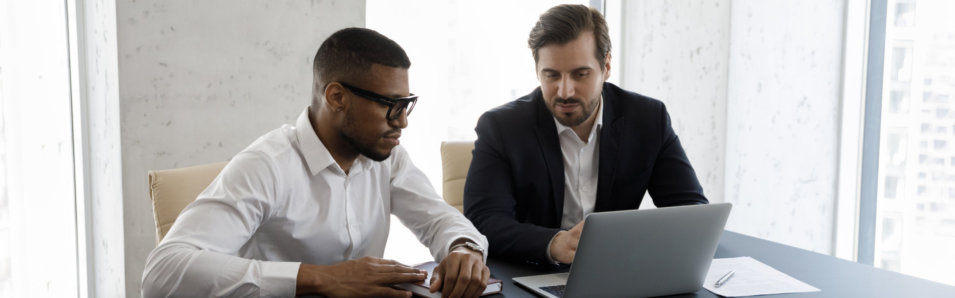 business man and his client looking at the laptop